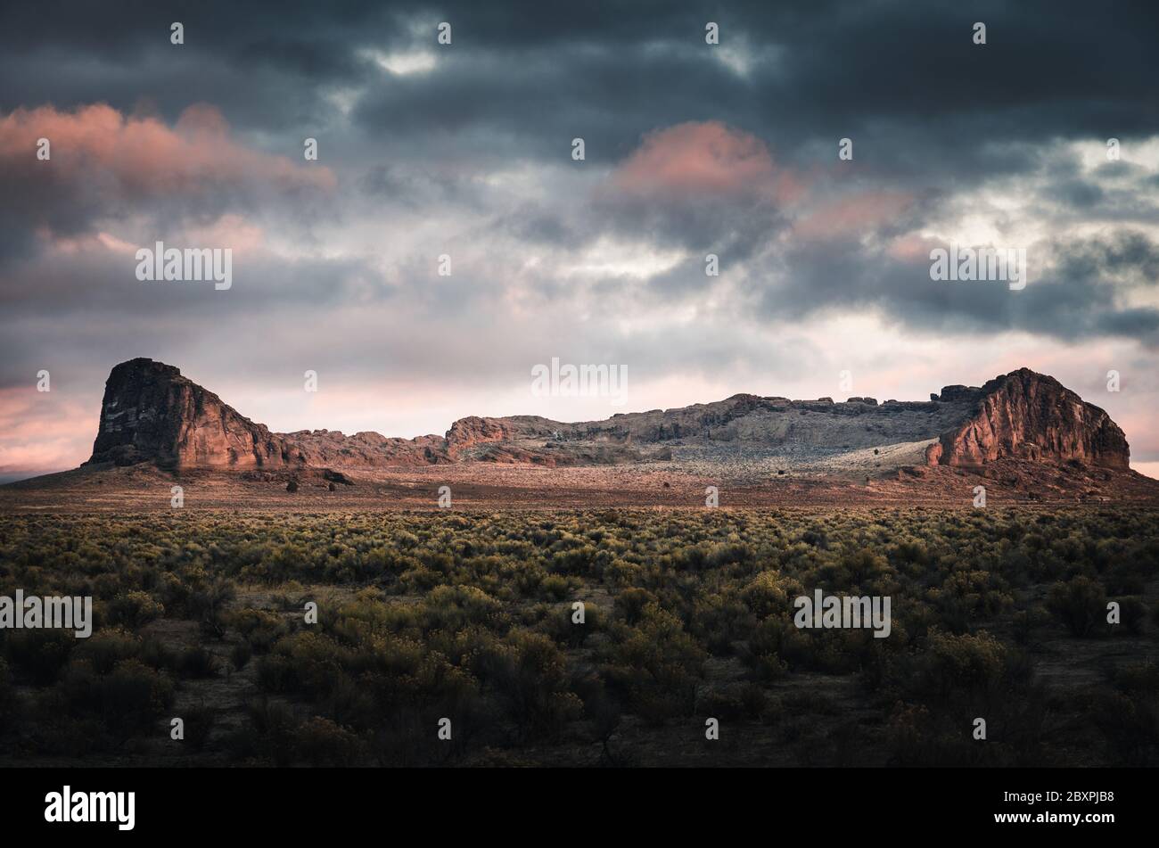 Fort Rock form circle of towering rock walls called a tuff ring. Stock Photo