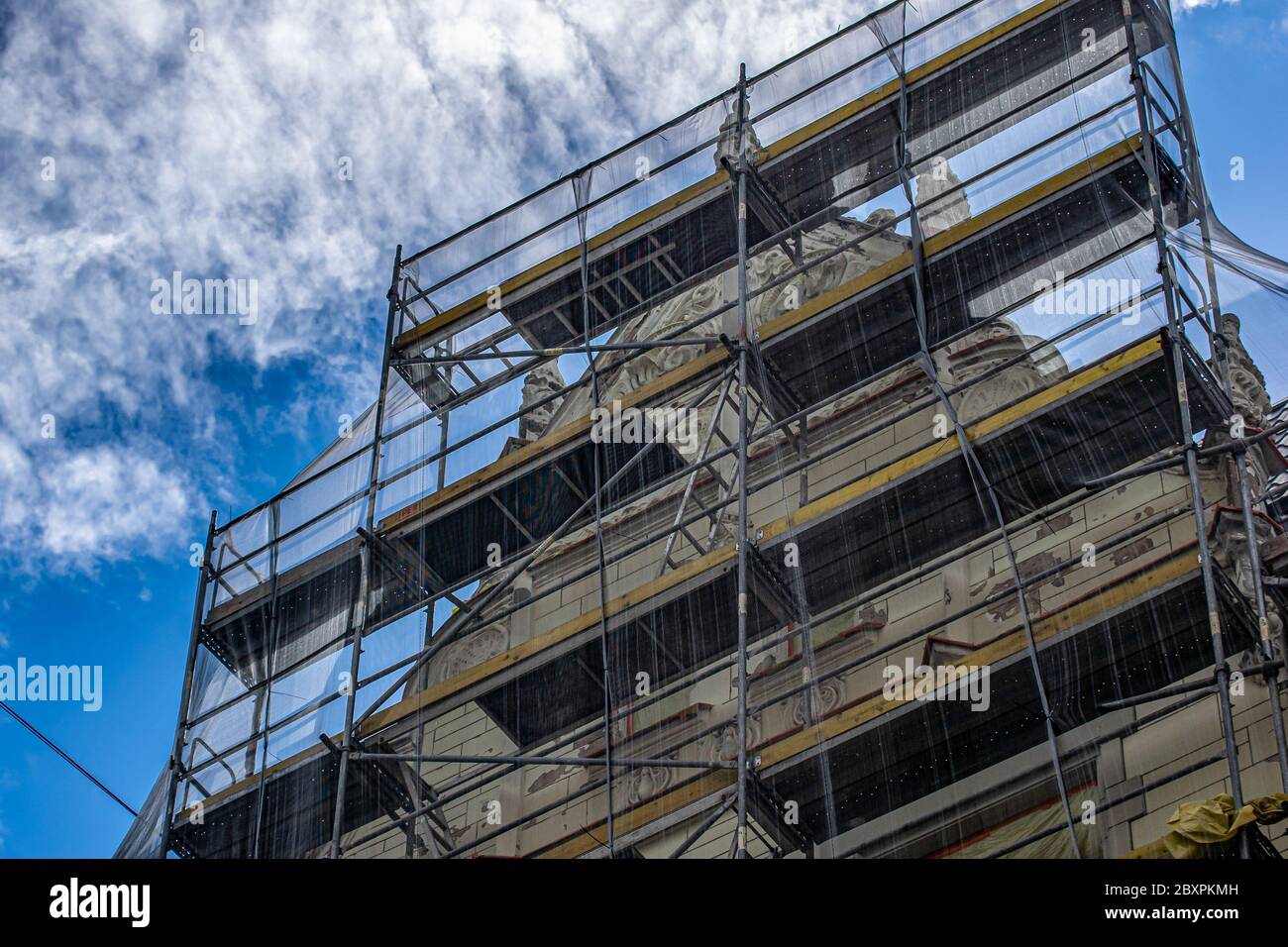 Facade of an old house in racks. Reconstruction of an old house with ...