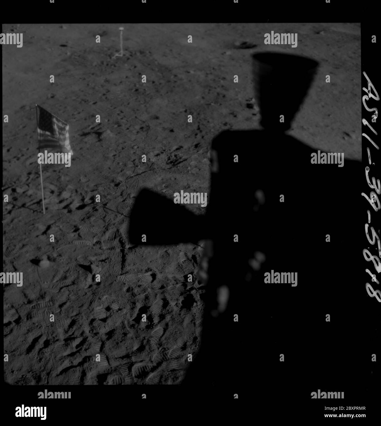 AS11-39-5818 - Apollo 11 - Apollo 11 Mission image - Shadow of LM thrusters and U.S. flag visible on lunar surface; Scope and content:  The original database describes this as: Description: Shadow of Lunar Module (LM) thrusters visible on lunar surface. United States (U.S.) flag visible also. Image taken from inside the LM after landing at Tranquility Base during the Apollo 11 Mission. Original film magazine was labeled Q.  Film Type: SO 3400 Panatomic-X Black/White taken with an 80mm lens.  Sun angle is Low. Approximate tilt angle is Low. Image was used to make a panoramic view of the moon. S Stock Photo