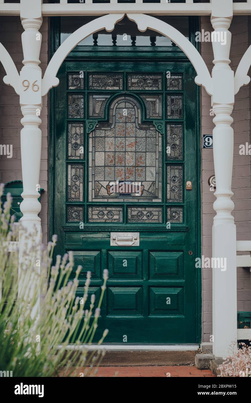 London, UK - May 26, 2020: Dark green stained glass front door of a