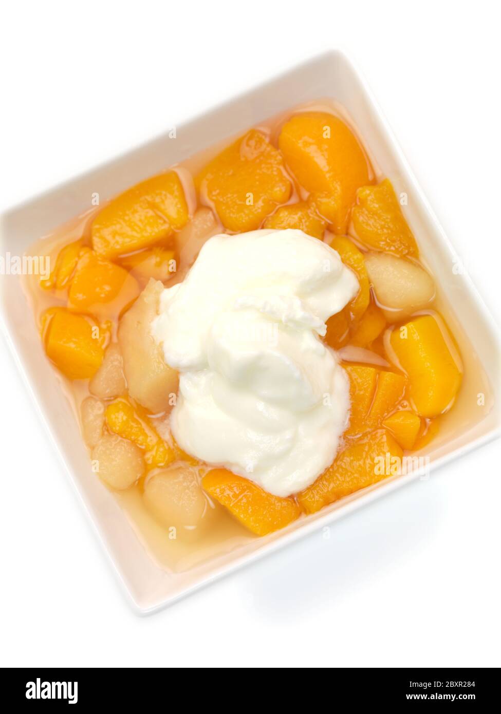 Diced pears and peaches in a fruit syrup Stock Photo