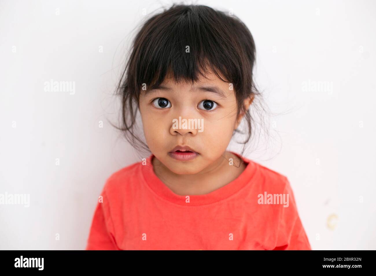 Portrait of girl with autism looking at camera with good eye contact Stock Photo