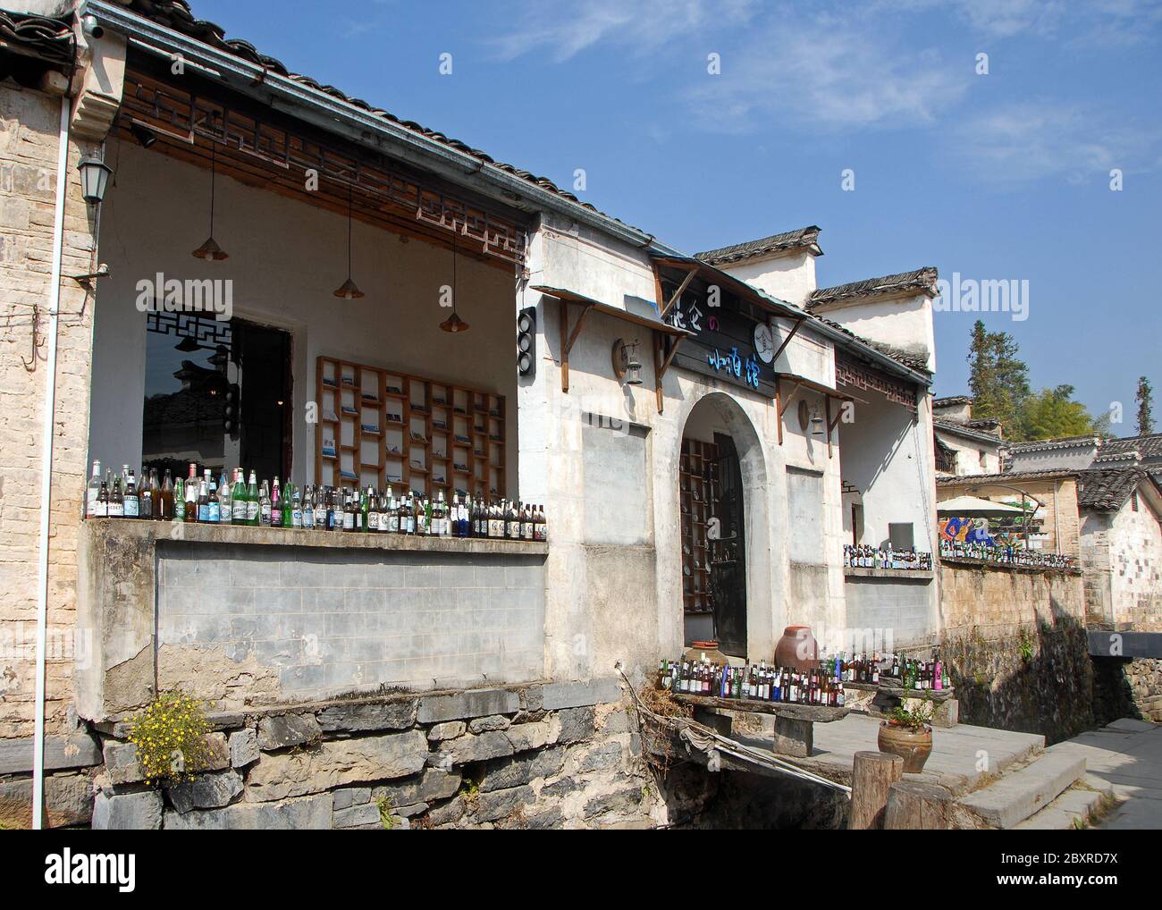 Xidi Ancient Town, Anhui Province / China - Nov 4 2019: A bar with bottles in a quiet street in the old town of Xidi called the Back Rivulet Stock Photo