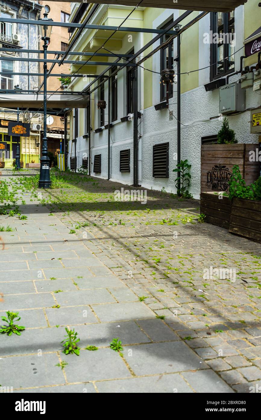 Empty tables at local restaurants in Old Town Bucharest due to coronavirus worldwide outbreak crisis. Deserted downtown, bar district in Bucharest, Ro Stock Photo