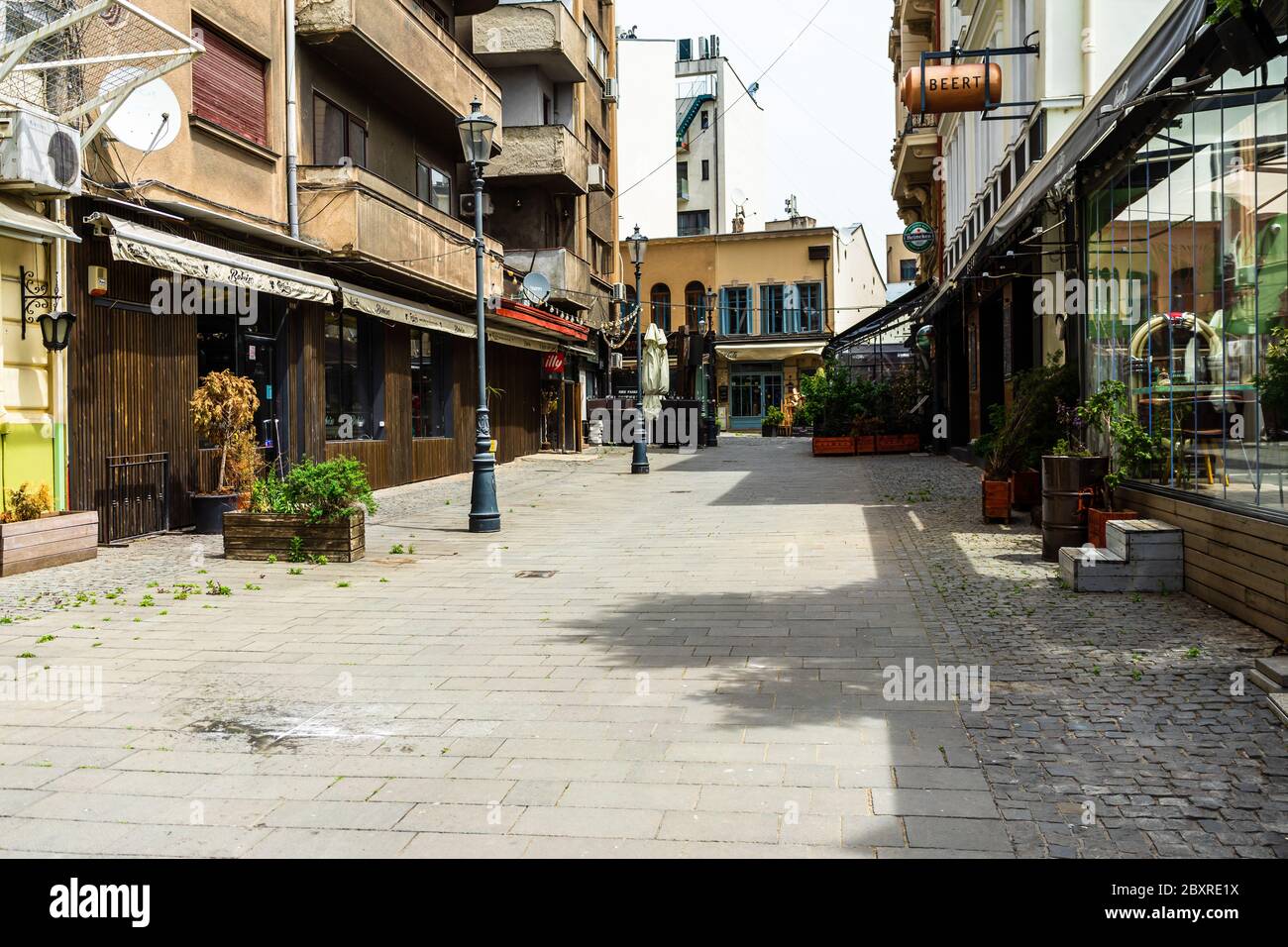 Empty tables at local restaurants in Old Town Bucharest due to coronavirus worldwide outbreak crisis. Deserted downtown, bar district in Bucharest, Ro Stock Photo