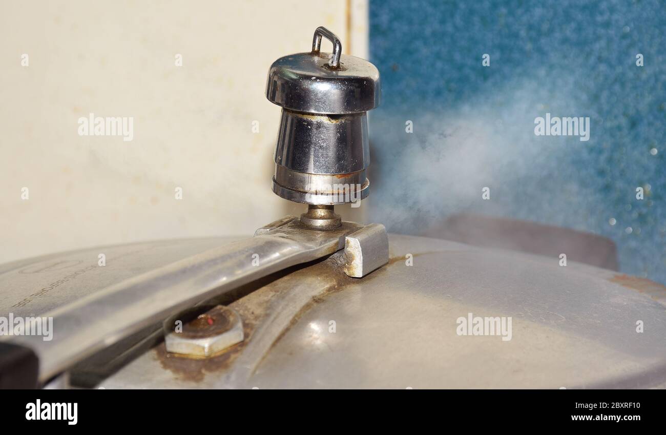Pressure Cooker releasing vapour or hot steam from its lid or gasket Stock Photo Alamy