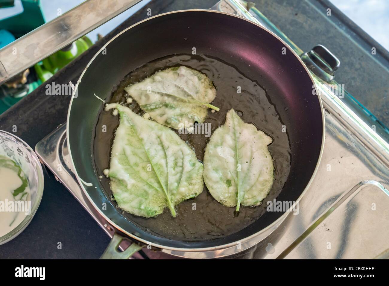 fried ChaPlu leaf (Wild Betel Leafbush) in the pan for eat with traditinal Thai food. Stock Photo