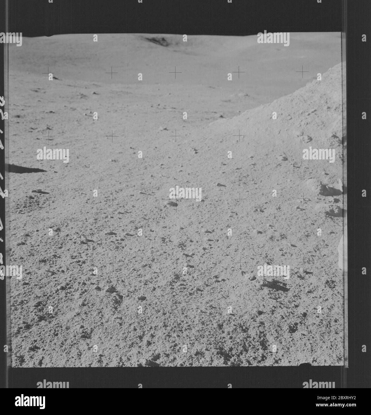 AS14-64-9130 - Apollo 14 - Apollo 14 Mission image - Pan of a large rock during EVA 2 with Old Nameless in the background.; Scope and content:  The original database describes this as: Description: Pan of a large rock during EVA 2 with Old Nameless in the background. Images were taken on the Surface during the Lunar Surface EVA for the Apollo 14 mission. Original film magazine was labeled LL,film type was S0267 (High Speed Black and White Thin Base),60mm lens with a sun elevation of 24 degrees and a Southern azimuth. Subject Terms: Apollo 14 Flight, Moon (Planet) Categories: EVA Original: Film Stock Photo