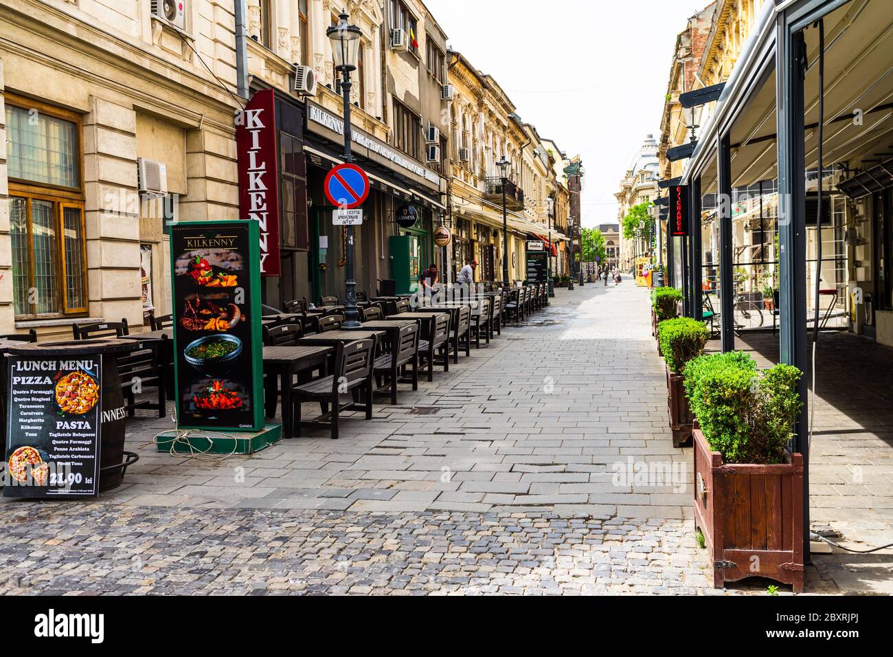 Empty tables at local restaurants in Old Town Bucharest due to coronavirus worldwide outbreak crisis. Deserted downtown, bar district in Bucharest, Ro Stock Photo