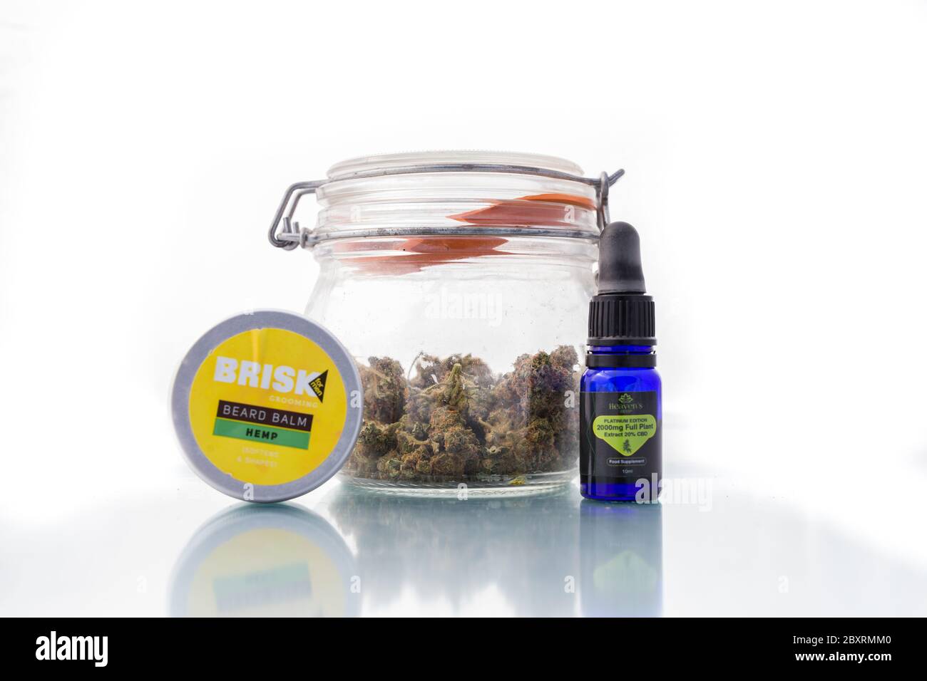 Suffolk, UK June 01 2020: A jar of cannabis along side some CBD products which are becoming ever more popular to the general public. Stock Photo
