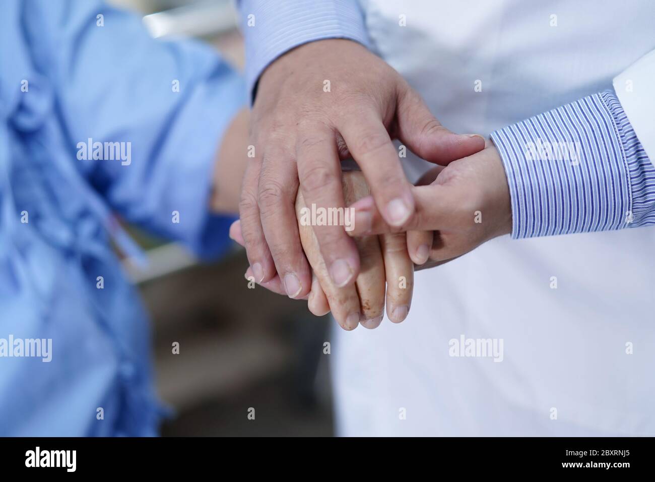 Holding Touching hands Asian senior or elderly old lady woman patient with love, care, helping, encourage and empathy at nursing hospital ward : healt Stock Photo