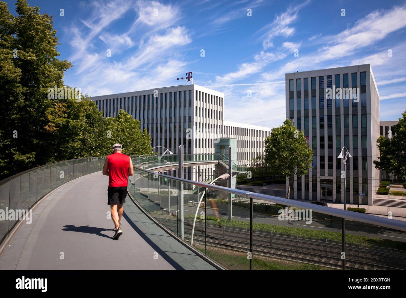 jogger on Telekom bridge over the Friedrich-Ebert-Allee, Office Port Bonn, Bonn, North Rhine-Westphalia, Germany.  Jogger auf Telekombruecke ueber die Stock Photo