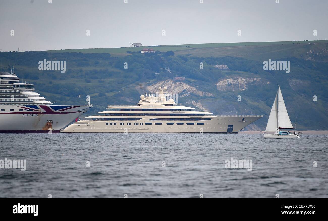 Weymouth, Dorset, UK. 8th June, 2020. Super yacht Dilbar, owned by Russian billionaire Alisher Usmanov, seen alongside the cruise ship Arcadia in Weymouth Bay. Credit: Dorset Media Service/Alamy Live News Stock Photo