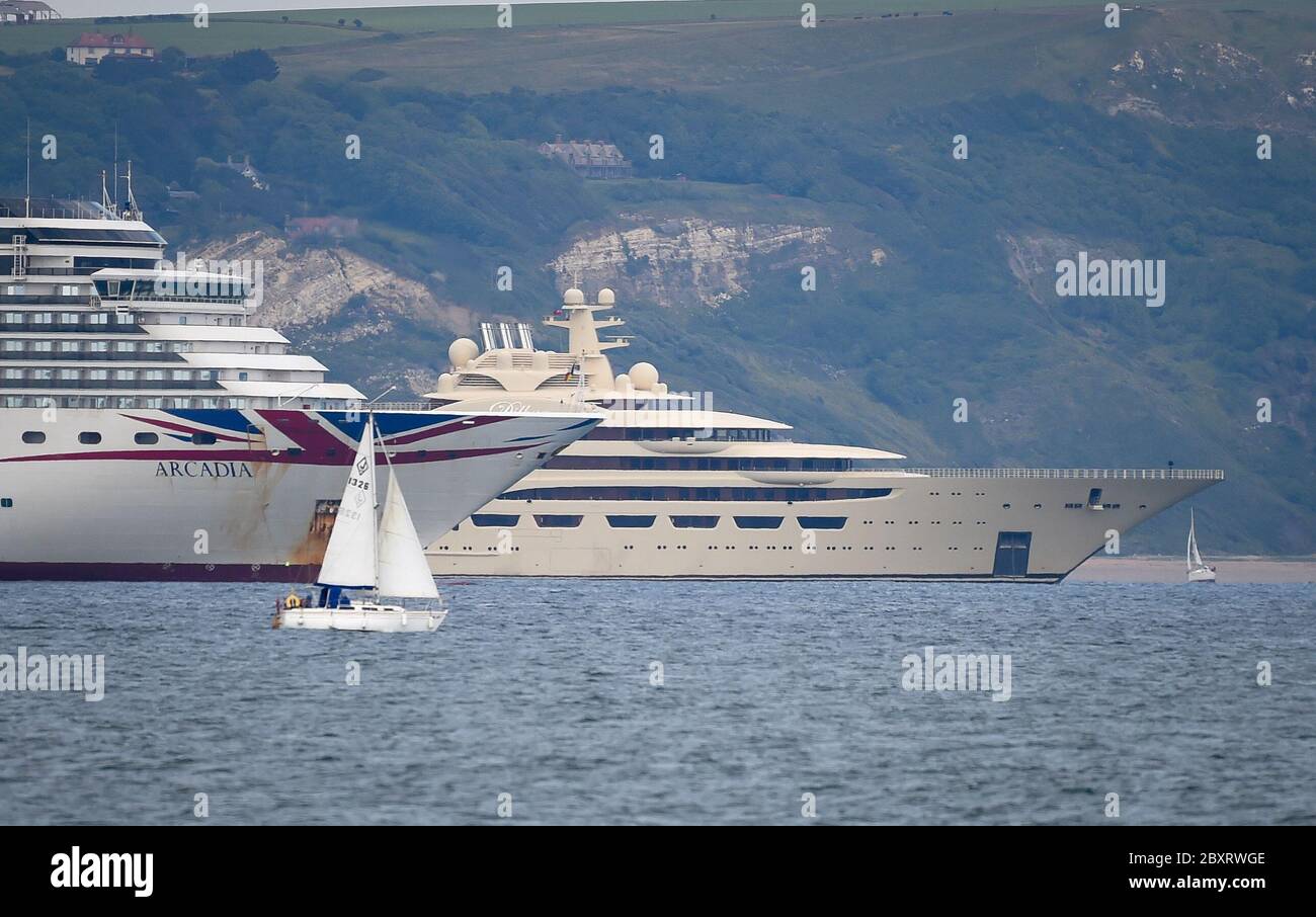 Weymouth, Dorset, UK. 8th June, 2020. Super yacht Dilbar, owned by Russian billionaire Alisher Usmanov, seen alongside the cruise ship Arcadia in Weymouth Bay. Credit: Dorset Media Service/Alamy Live News Stock Photo