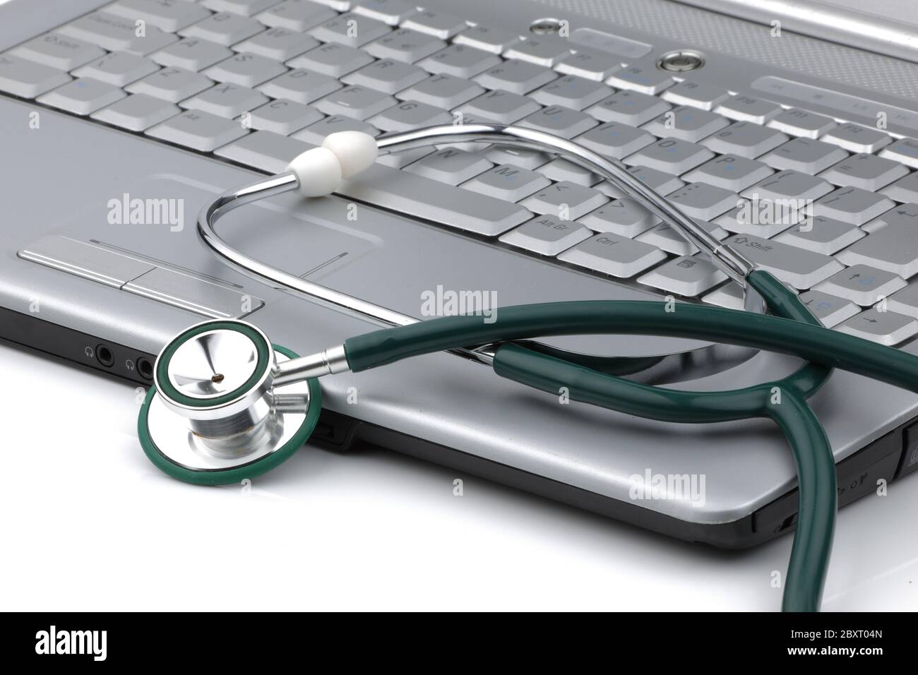 stethoscope next to a laptop signifying the relationship of information technology and medicine Stock Photo