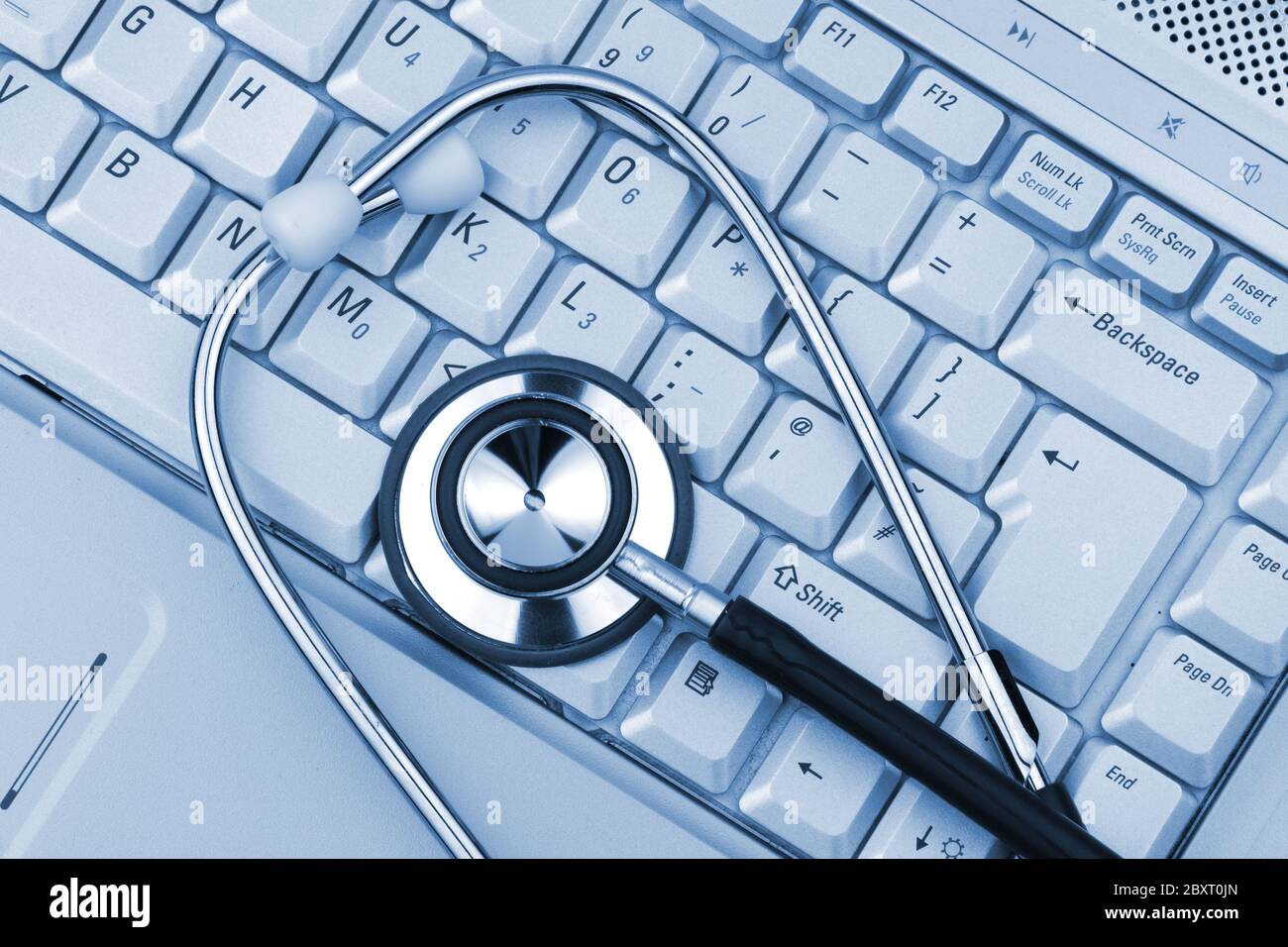PC and stethoscope in clinical blue light Stock Photo