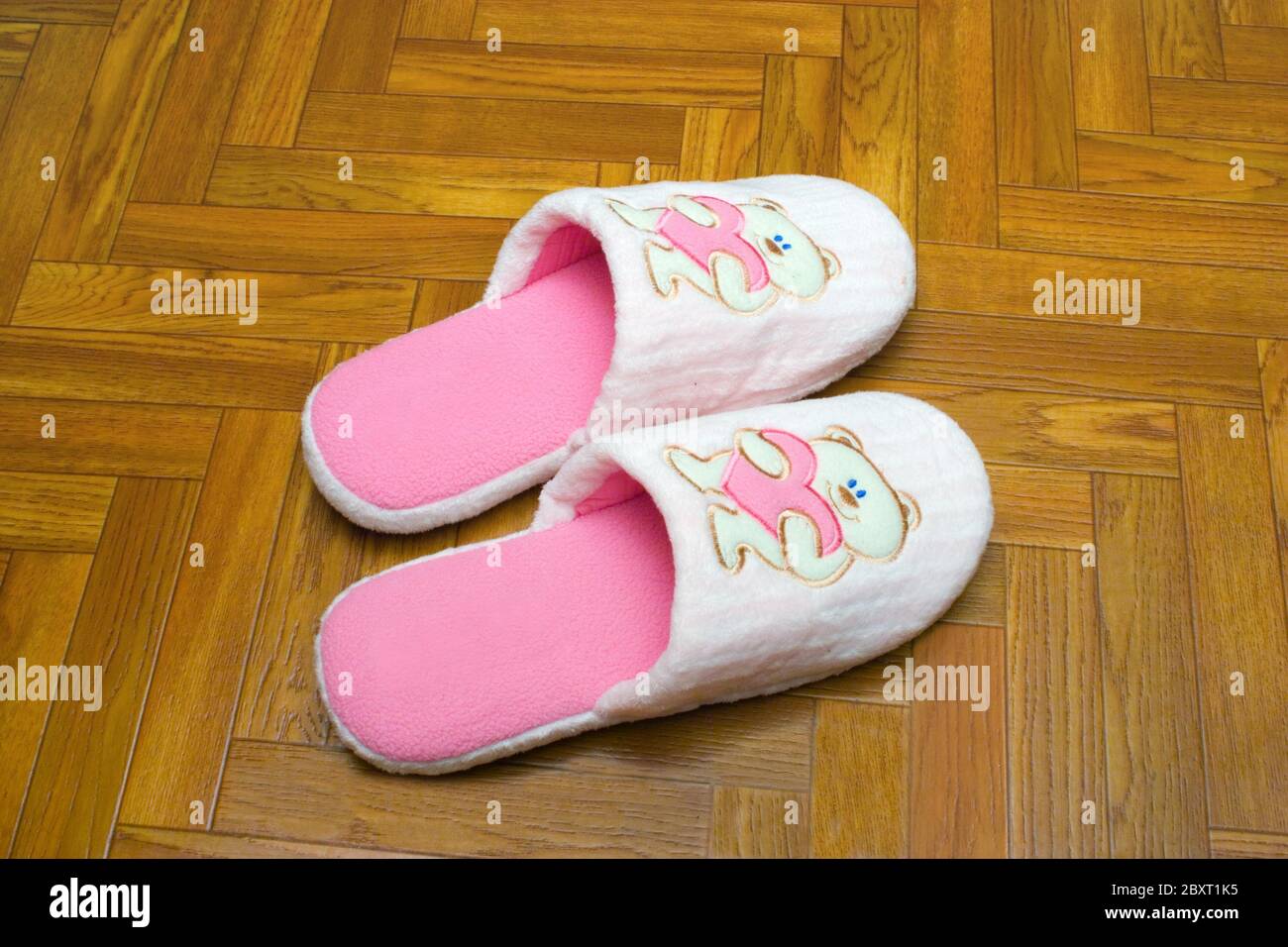Childlike slippers on parquet Stock Photo