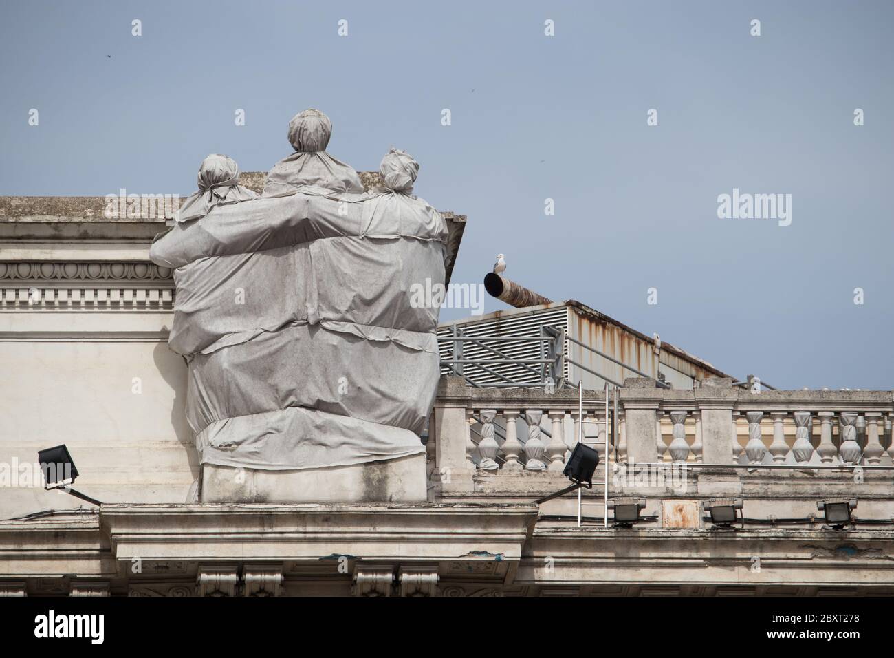 statues wrapped in protective sheets due to a restoration in Rome Stock Photo