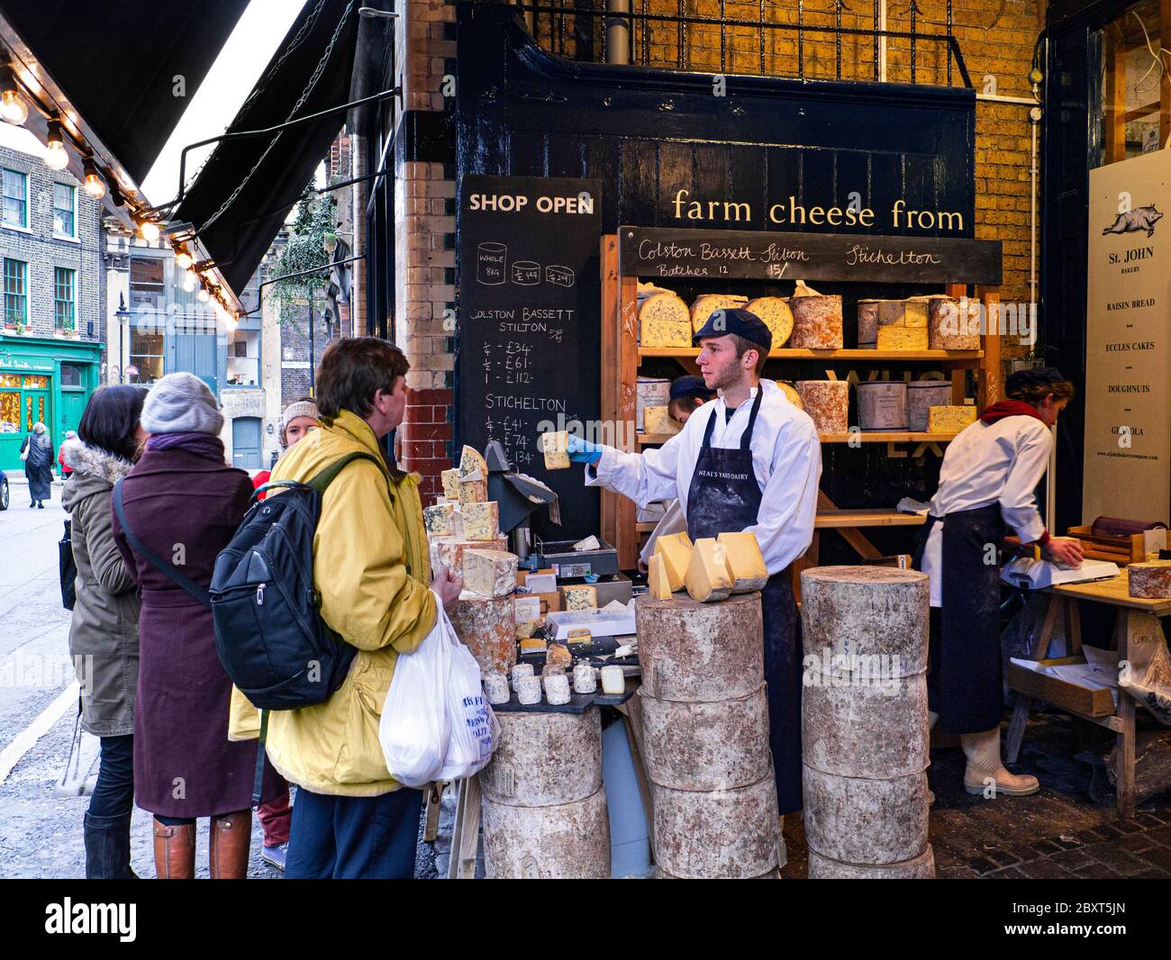 Neals Yard Dairy outdoor display and tasting market stall English cheese shop outdoor stall & customers at Borough Market London Bridge Southwark  London UK Stock Photo