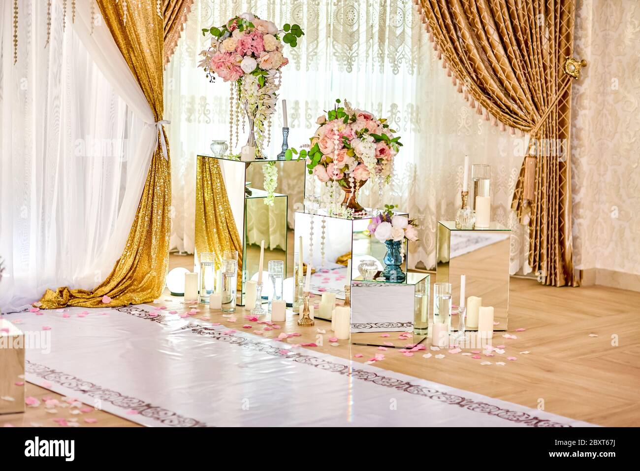 Wedding decoration in the restaurant using mirror and artificial flowers. Registration zone for bride and groom. Wedding ideas for decoration. u Stock Photo