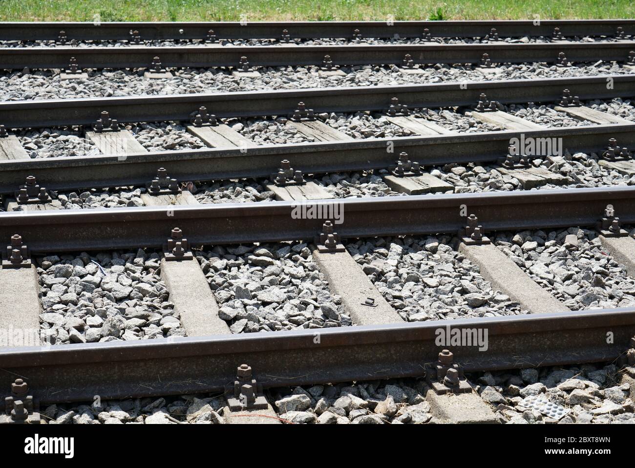 Hardened steel railroad tracks photographed on a sunny spring day Stock