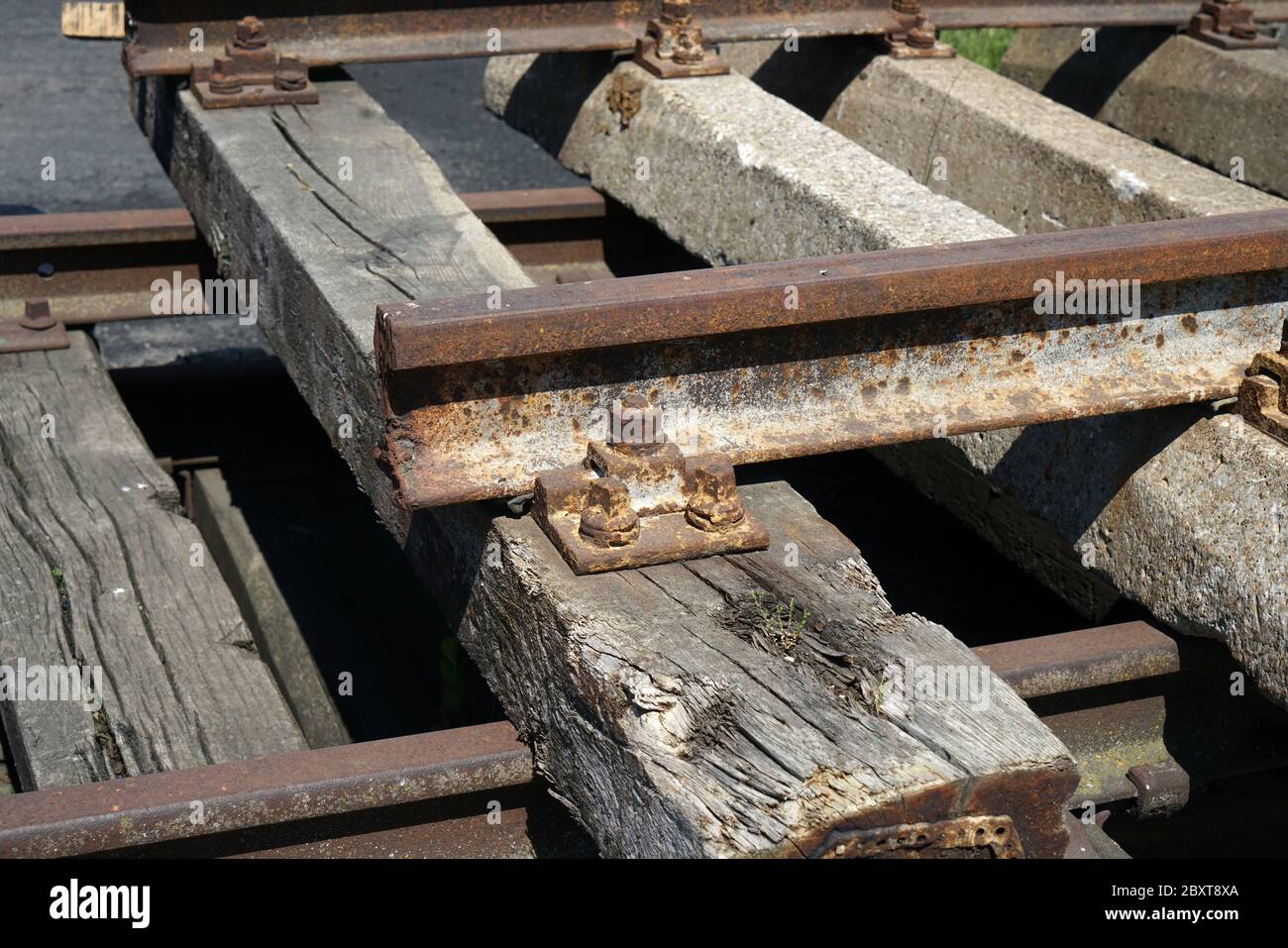 Hardened steel railroad tracks photographed on a sunny spring day Stock