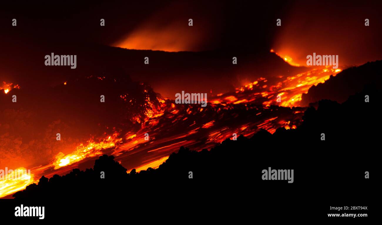 Lava flow on during eruption of Etna volcano in Sicily Stock Photo
