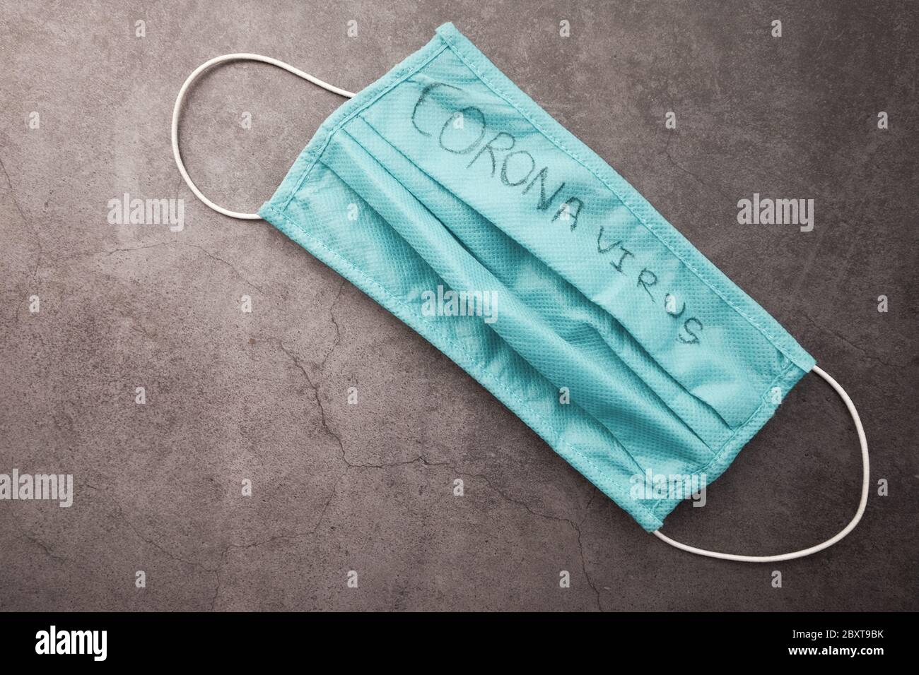 Surgical masks with rubber ear straps drop on gray background Stock Photo Alamy