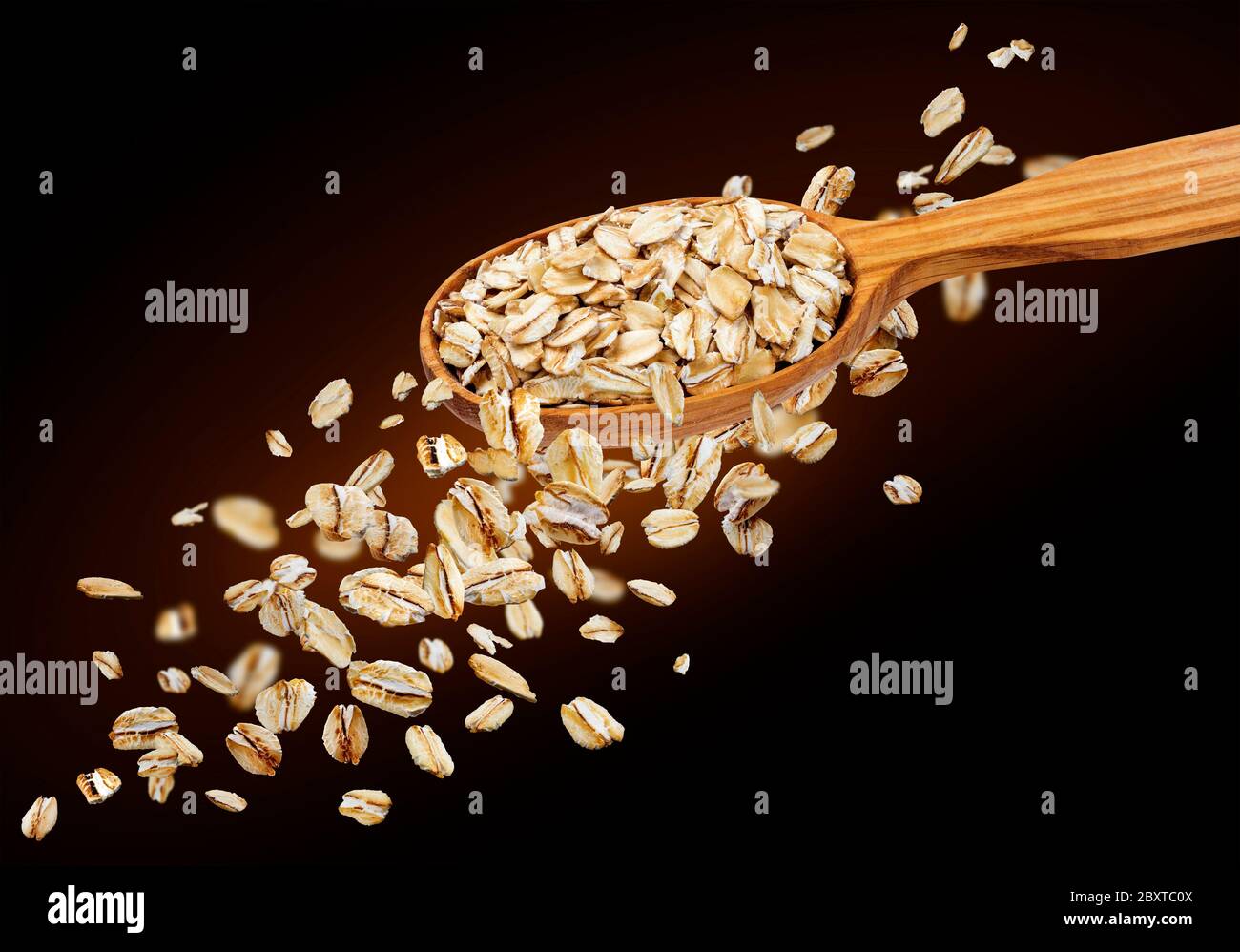 Falling oat flakes isolated on black background Stock Photo