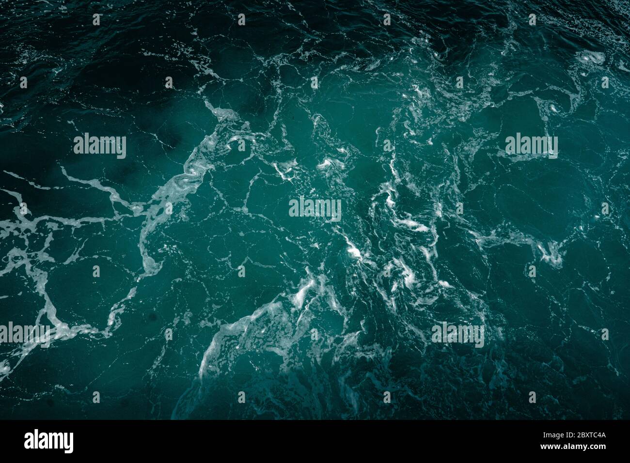 Top aerial view of deep blue waters of ocean with white foam. Drone ...