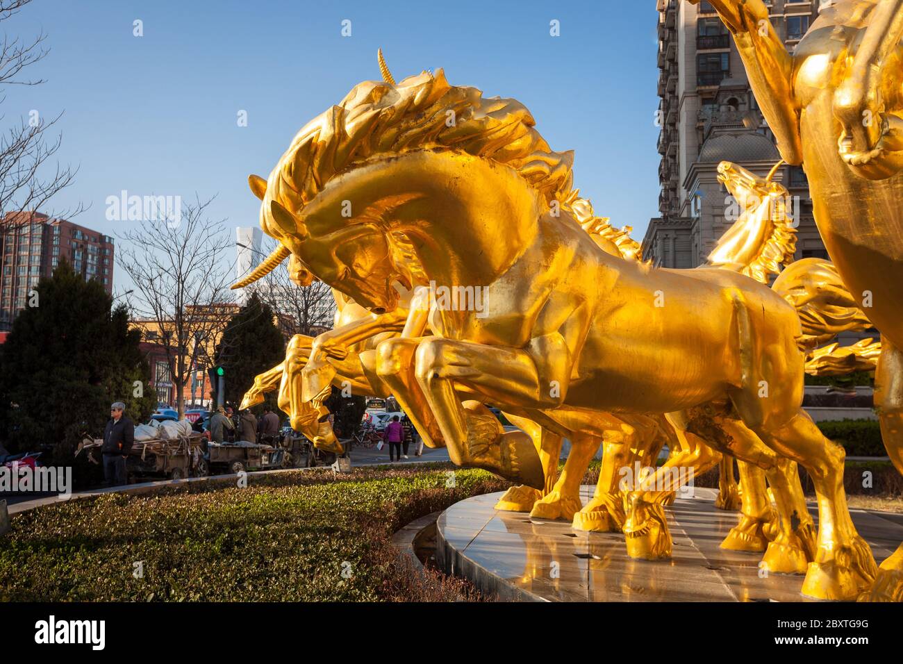 Beijing / China -  : Roman soldier or Apollo in the chariot hitched up in gold covered unicorns - monument at the entrance to apartments complex Stock Photo