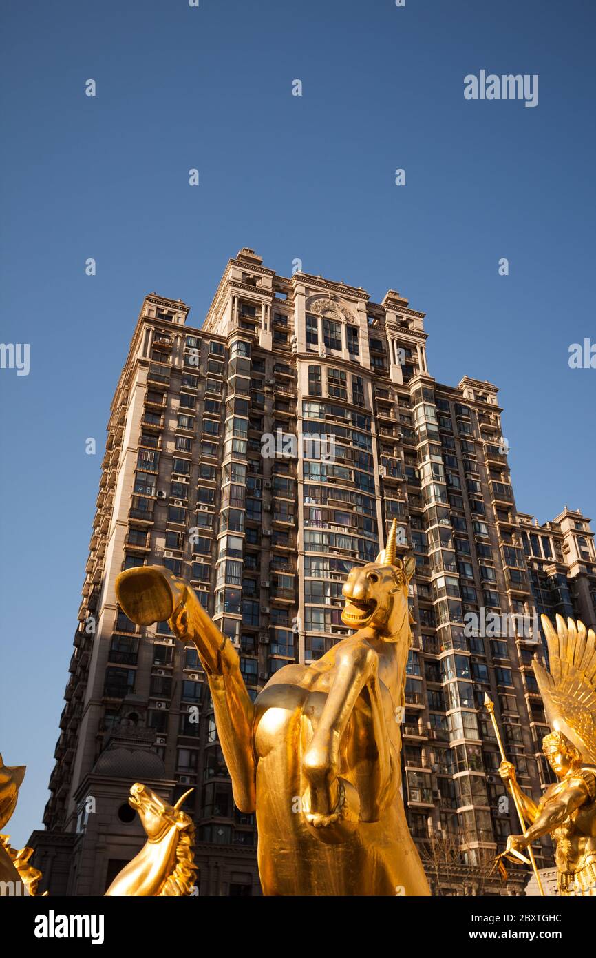 Beijing / China -  : Roman soldier or Apollo in the chariot hitched up in gold covered unicorns - monument at the entrance to apartments complex Stock Photo