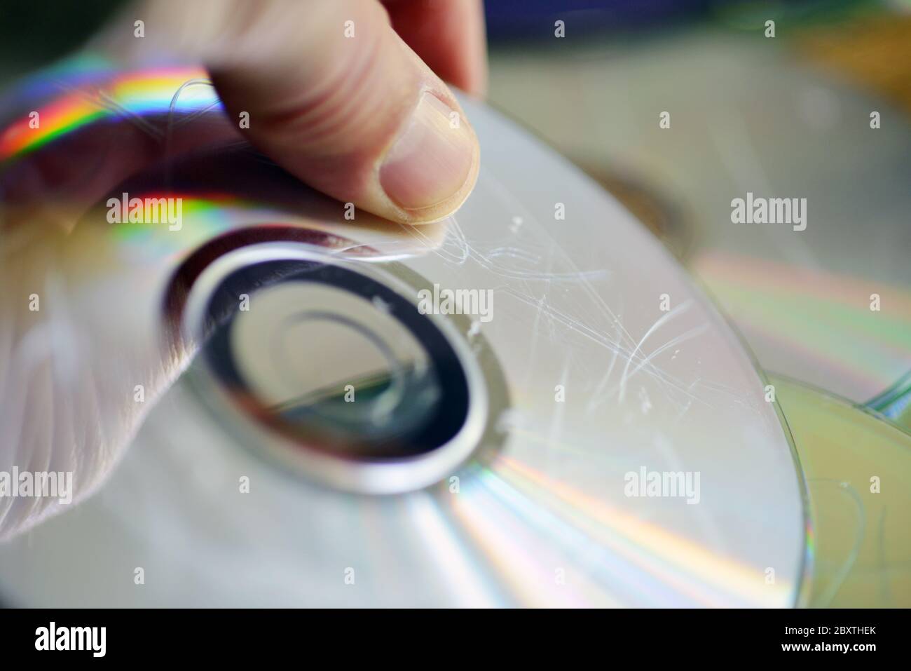 Damaged disc with scratches hold by a hand Stock Photo Alamy