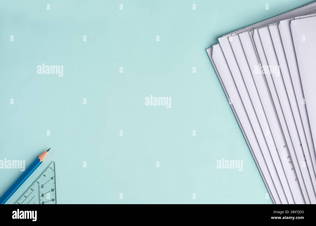 Stack Folding drawings on a blue background. Top view. Flat lay. Copy space Stock Photo