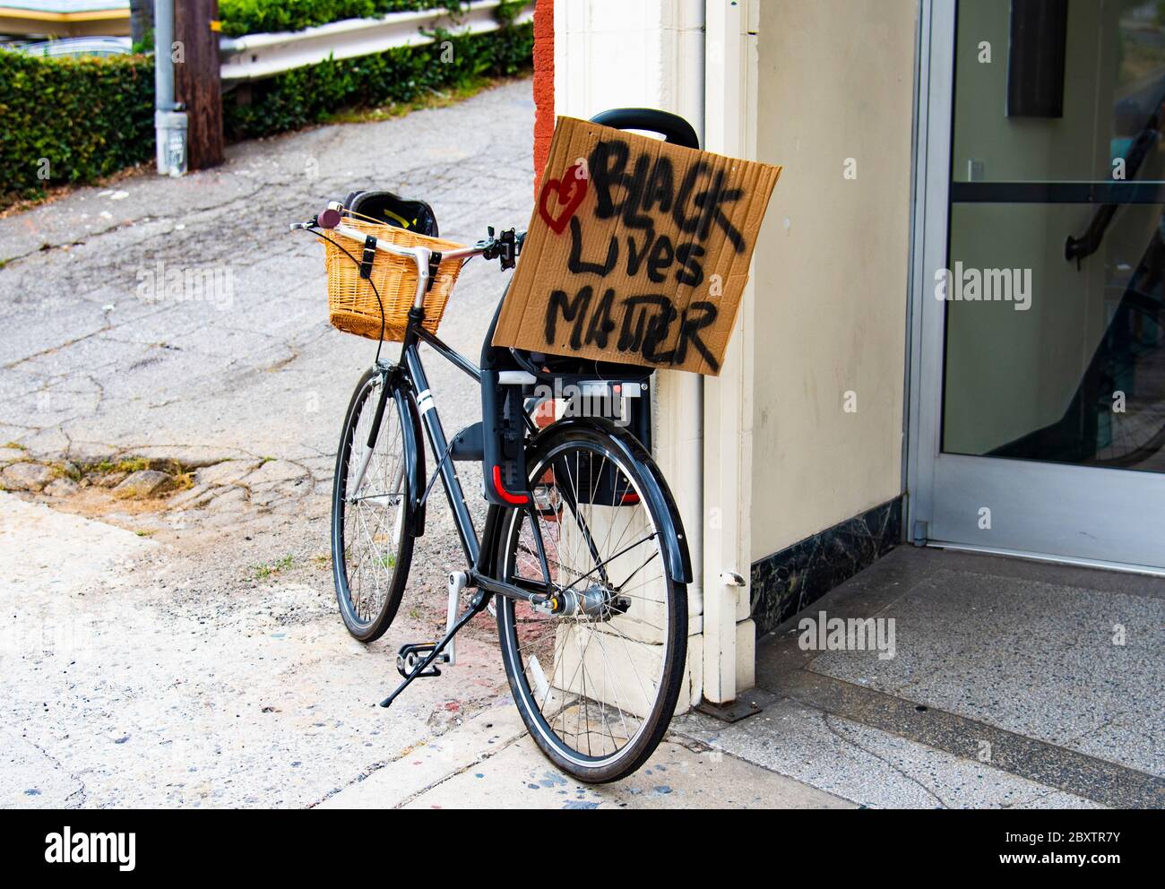 Parked bicycle with a Black Lives Matter sign during a George Floyd protest rally in Los Angeles, CA Stock Photo