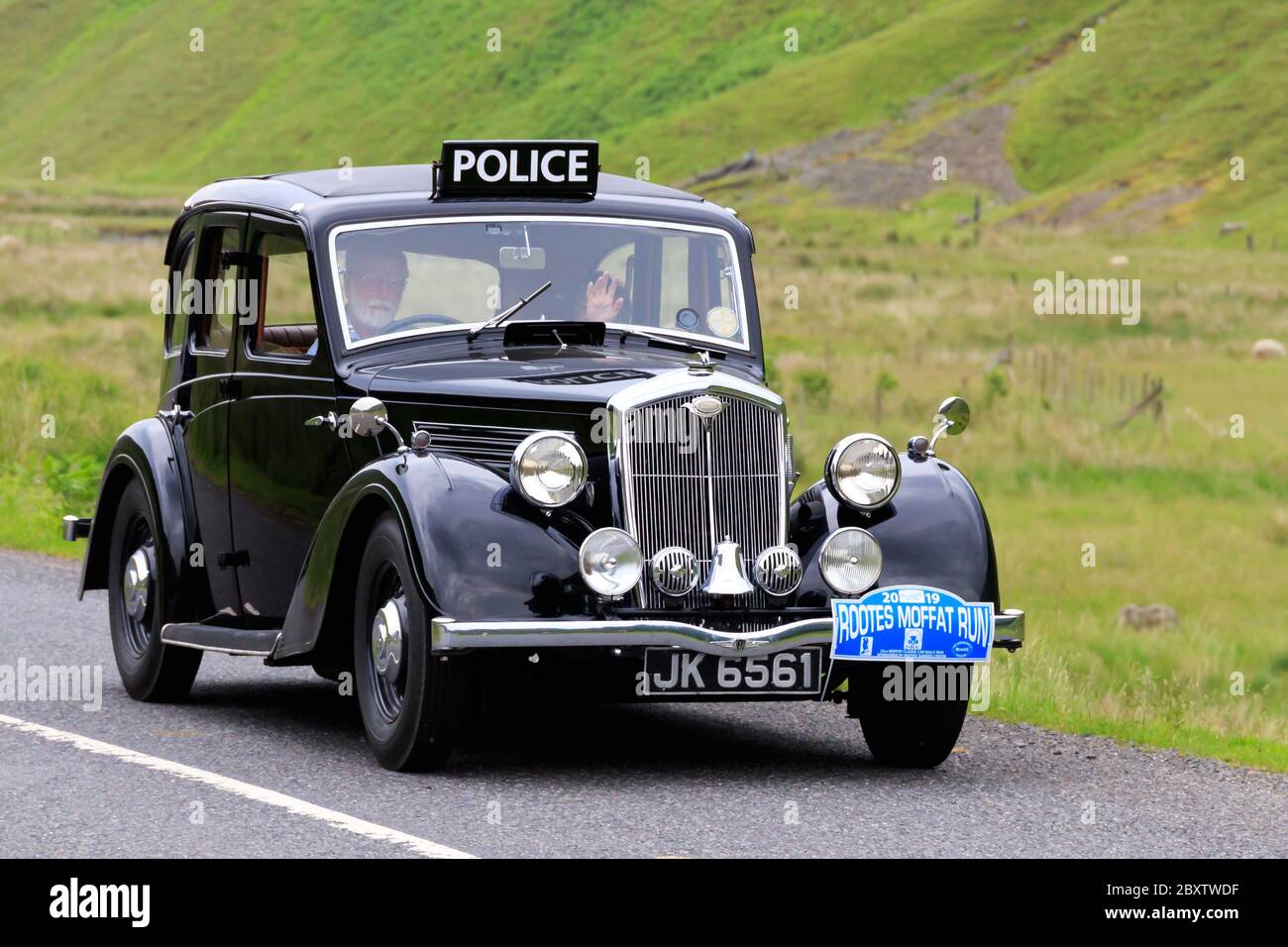 MOFFAT, SCOTLAND - JUNE 29, 2019: 1937 Wolseley Fourteen Fifty-Six police car in a classic car rally en route towards the town of Moffat, Dumfries and Stock Photo