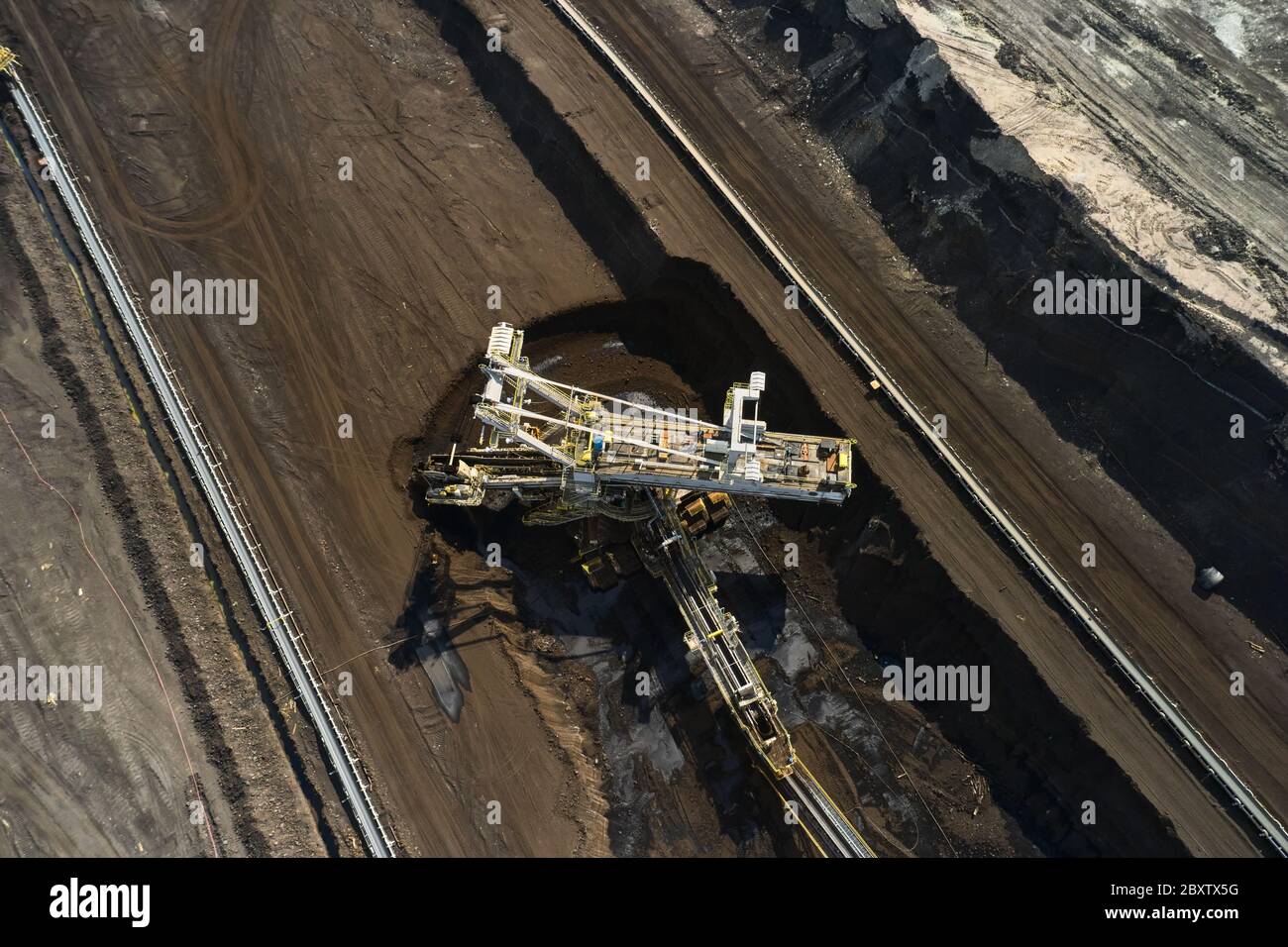 Bucket wheel excavator in a lignite quarry in process, Heavy industry.  Stock Photo