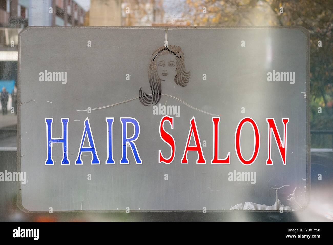 London, UK - November 16, 2019 - Sign of a hair salon located at Barbican estate complex Stock Photo
