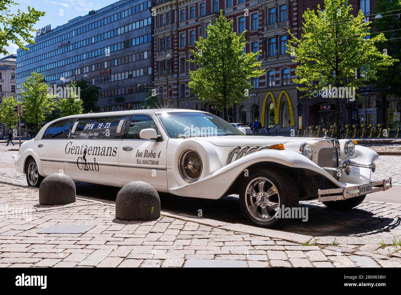 Modern marketing. Vintage Excalibur car wit logos left parked at main street downtown Helsinki. Parking tickets are cheaper than paid advertisement. Stock Photo