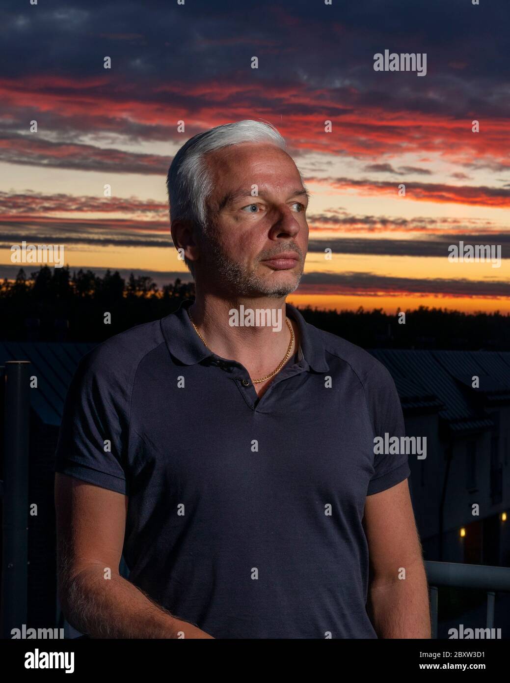 Dramatic one flash portrait of a man with sunset as background Stock Photo