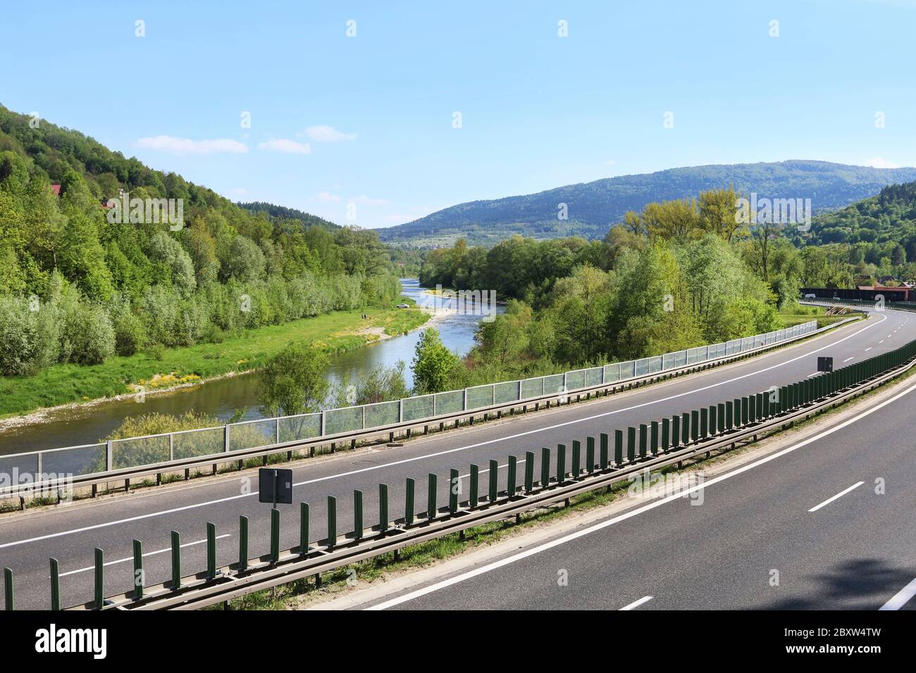 A multilane road passes through areas of high landscape value. Highway