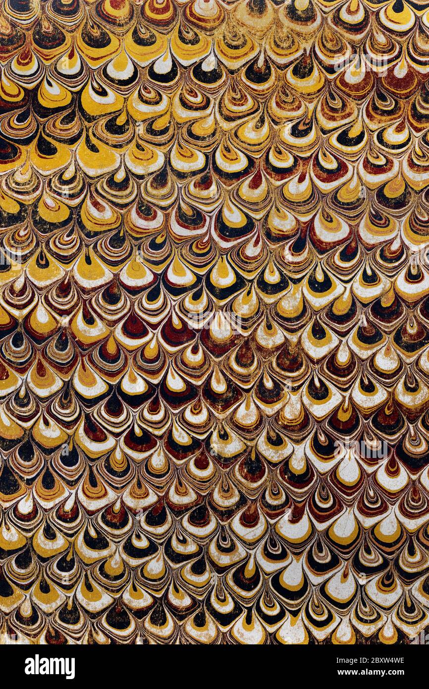 Historic worn endpaper marbling with an abstract design used inside an 1890 book cover Stock Photo