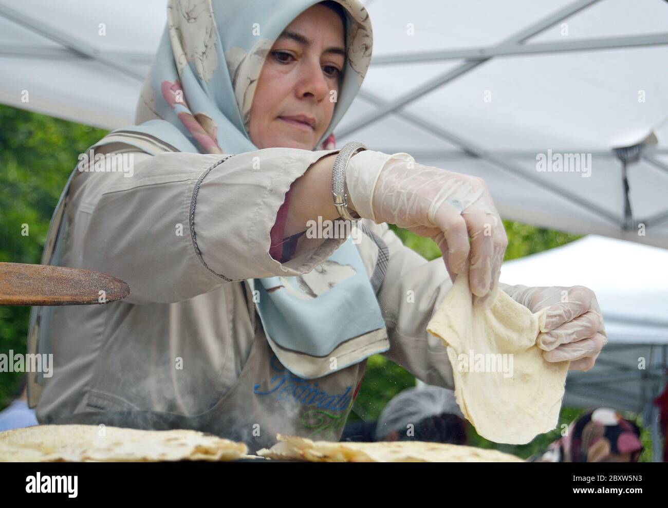 Bucharest, Romania. May 22, 2016. Turkish woman baking traditional flat bread at the Turkish Festival in Bucharest Stock Photo
