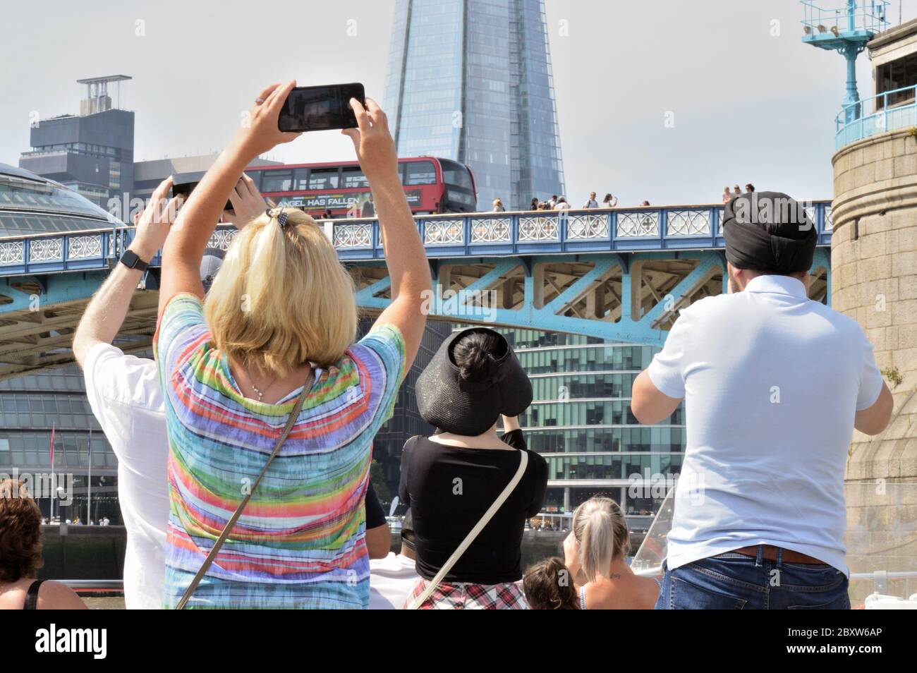 London, UK - August 24, 2019 - Multi ethnic group of tourists photographing landmarks in London. Stock Photo