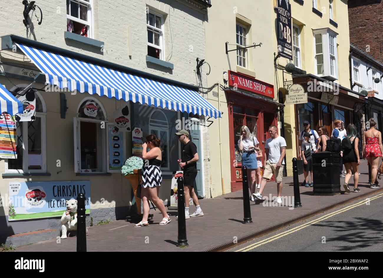 Tourists visitors queueing at ice cream shop in Ironbridge, Shropshire during the Covid-19 Coronavirus pandemic lockdown Britain, Uk, 2020 Stock Photo