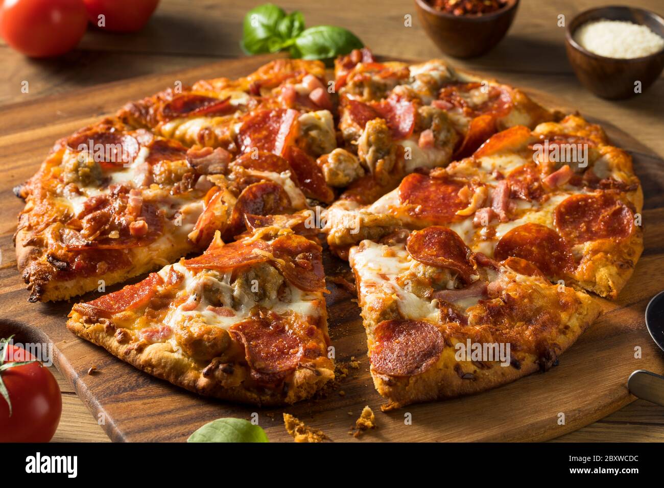 Savory Homemade Meat Lovers Pizza with Pepperoni and Bacon Stock Photo