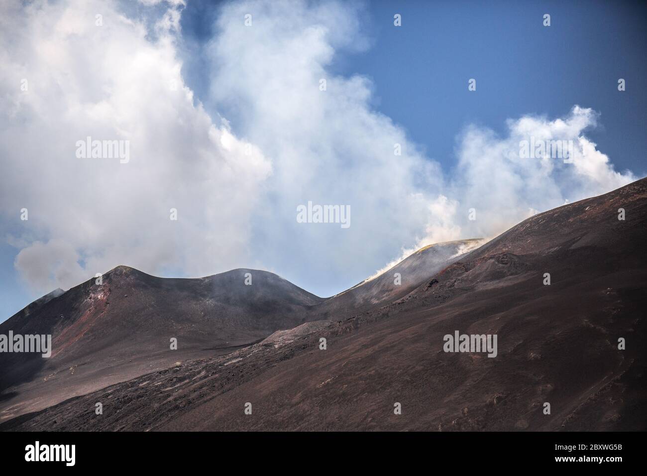 Etna Volcano with smoke and ash during eruption from top crater at sunset Stock Photo