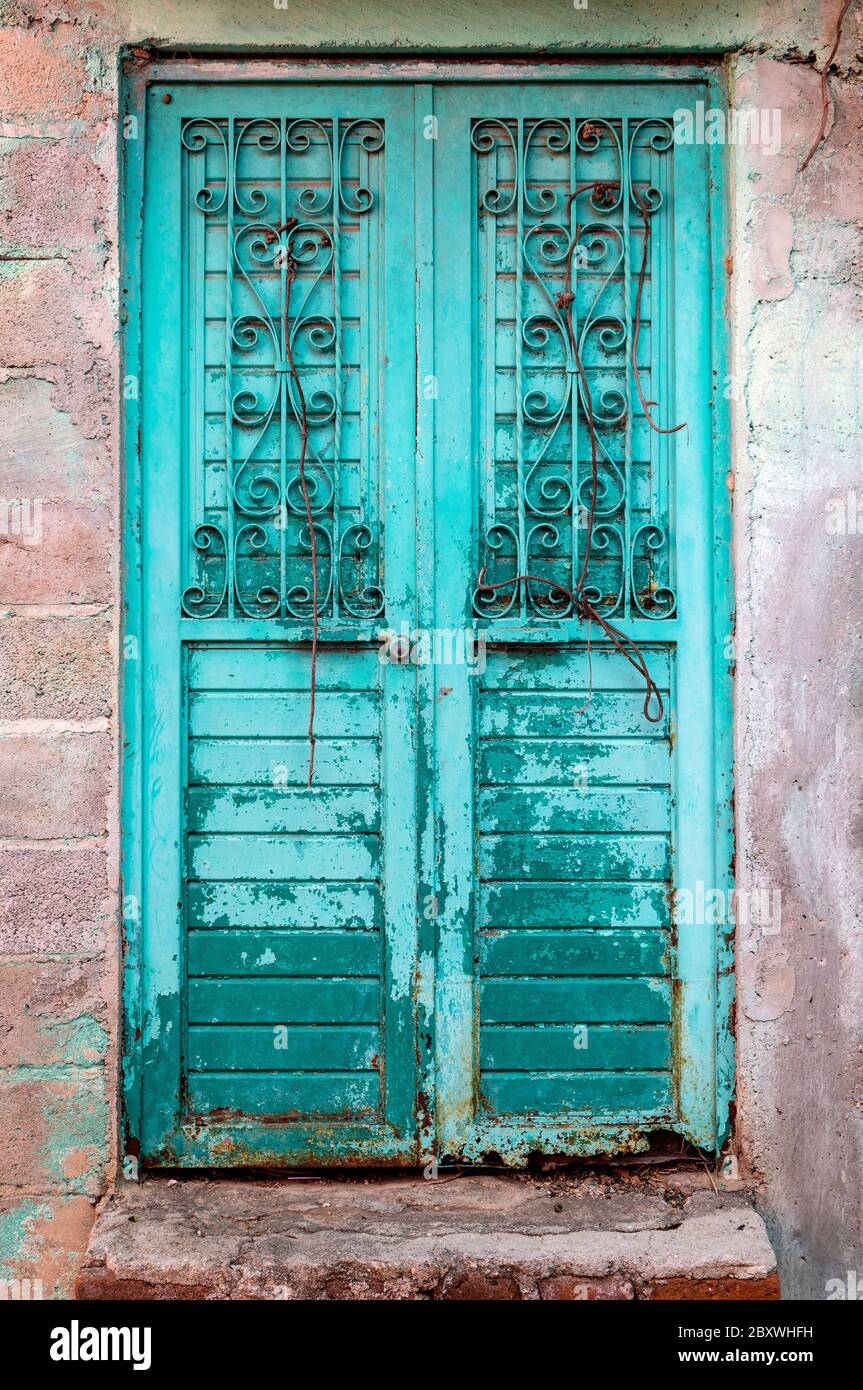 Retro style turquoise metallic door in San Cristobal de las Casas, Chiapas, Mexico. Stock Photo