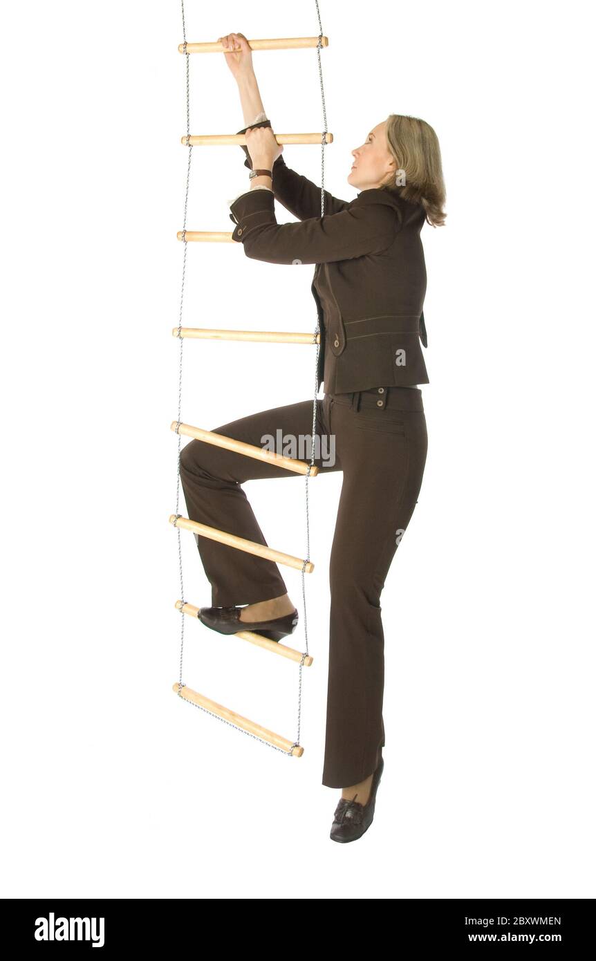 An isolated photo of a businesswoman climbing a ropeladder Stock Photo