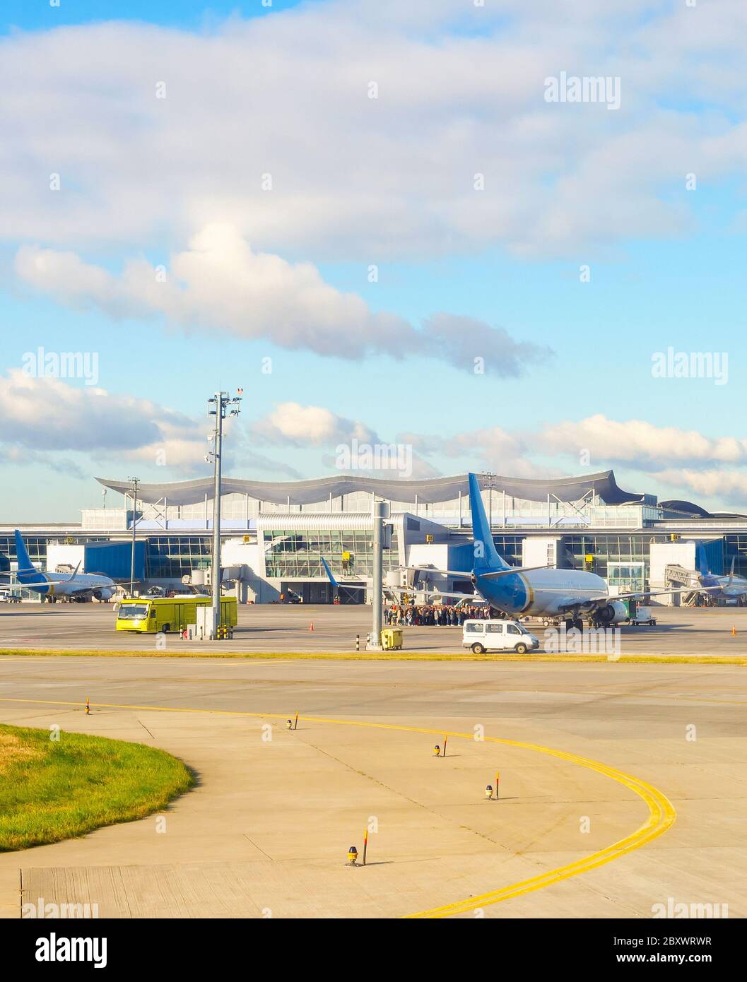 Boryspil airport scene, airplanes, bus and passengers queue at airfield. Kyiv, Ukraine Stock Photo
